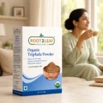 Root2Leaf Organic Triphala Powder product pack in a lifestyle studio setting